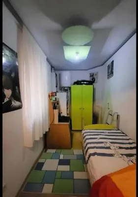 a bedroom with a bed and a green cabinet at appartement Laken Belgique in Brussels