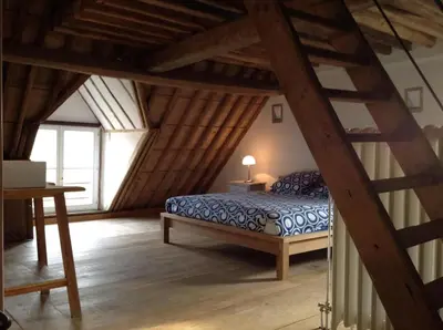 a bedroom with a bed in a attic at Beautiful 19th-century house in the countryside in Glabbeek