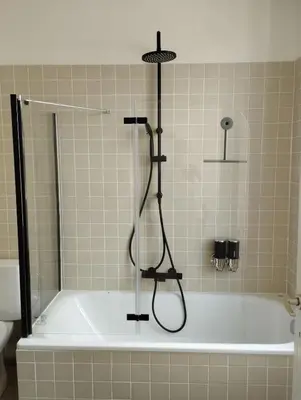 a shower in a bathroom with a bath tub at NiceFlatInTheStad in Antwerp