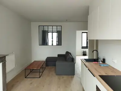 a living room with a couch and a table at NiceFlatInTheStad in Antwerp