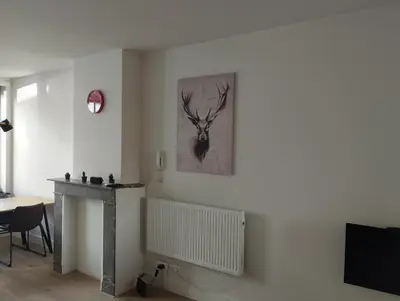 a living room with a picture of a deer on the wall at NiceFlatInTheStad in Antwerp