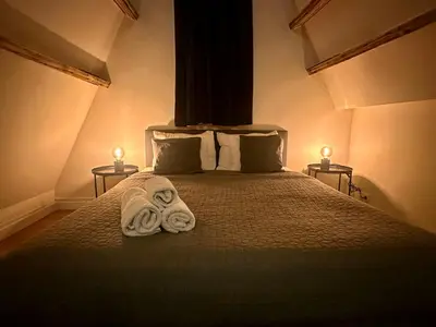 a bedroom with a bed with two towels on it at Luxury Rooms by Rikas Hotels in Antwerp