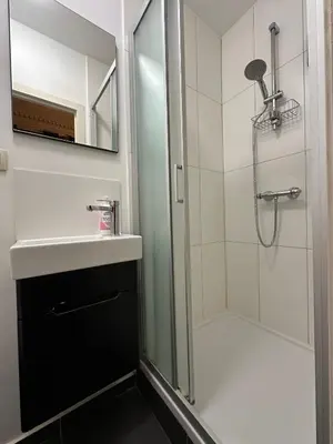 a bathroom with a shower and a sink at Luxury Rooms by Rikas Hotels in Antwerp