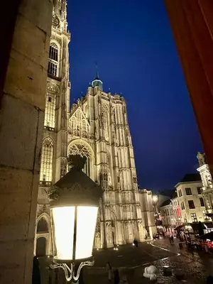 a large cathedral with a light in front of it at Luxury Rooms by Rikas Hotels in Antwerp
