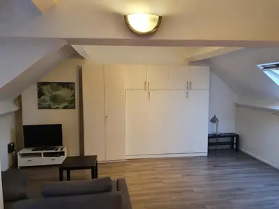 a living room with a couch and a tv at Studio meublé in Zaventem