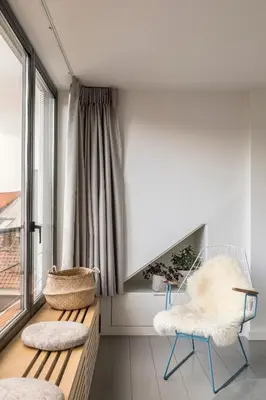 a room with a bench and a chair and a window at Canopée guesthouse in Brussels