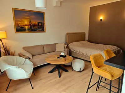 a living room with a couch and a bed and a table at Brussels Cozy Studio in Brussels
