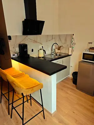 a kitchen with a black counter and a sink at Brussels Cozy Studio in Brussels
