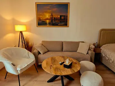 a living room with a couch and a table at Brussels Cozy Studio in Brussels