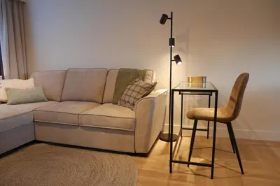 a living room with a couch and a table and a chair at Parus major in Londerzeel