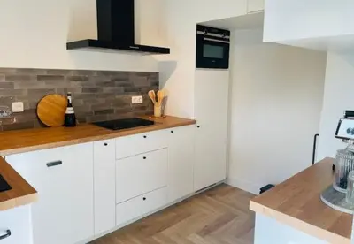 a kitchen with white cabinets and a counter top at Parus major in Londerzeel