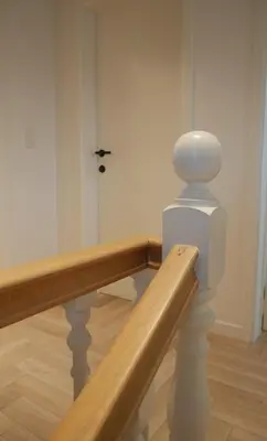 a staircase in a room with a wooden rail at Parus major in Londerzeel