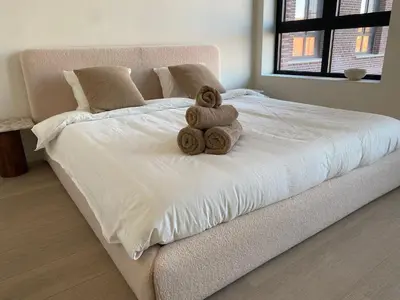 a white bed with two teddy bears on it at Verliefd in Antwerpen in Antwerp