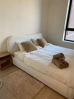 a bed with a teddy bear sitting on it at Verliefd in Antwerpen in Antwerp