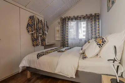 a bedroom with a bed and a window at Kweni House in Brussels