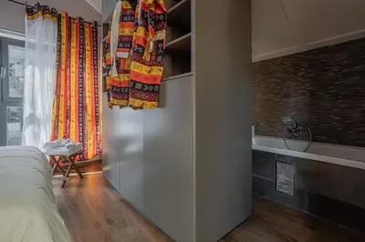 a bedroom with a bed and a tub in a room at Kweni House in Brussels