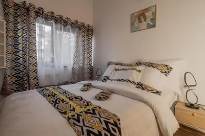 a bedroom with a bed and a window at Kweni House in Brussels