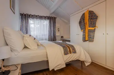 a bedroom with a bed and a window at Kweni House in Brussels