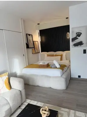 a bedroom with a large bed and a couch at Charming apartment in Bruxelles in Brussels