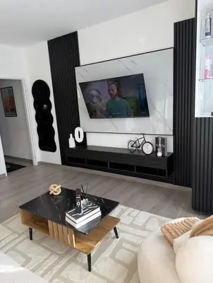 a living room with a tv and a coffee table at Charming apartment in Bruxelles in Brussels