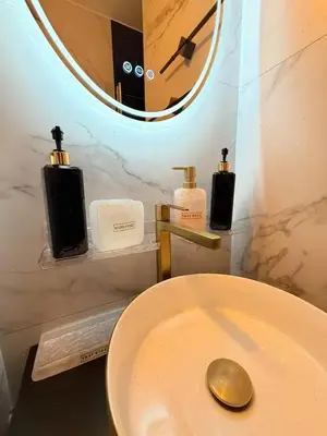a bathroom with a toilet with a mirror and a sink at Charming apartment in Bruxelles in Brussels