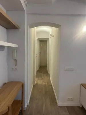 an empty hallway with white walls and wooden floors at Large 3-bedroom apartment in Bruxelles in Brussels