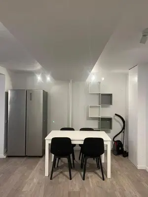 a room with a table and chairs and a refrigerator at Large 3-bedroom apartment in Bruxelles in Brussels