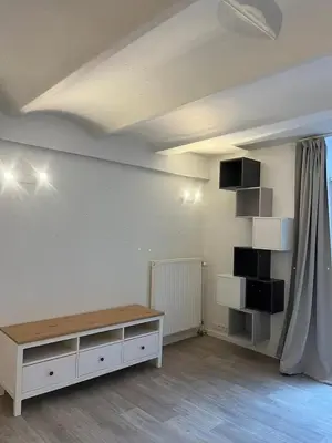 a white room with a table and a shelf at Large 3-bedroom apartment in Bruxelles in Brussels