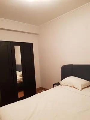 a bedroom with a white bed and a mirror at Central cosy apartment in Brussels