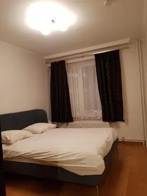 a bedroom with a bed in front of a window at Central cosy apartment in Brussels