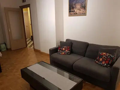 a living room with a couch and a coffee table at Central cosy apartment in Brussels
