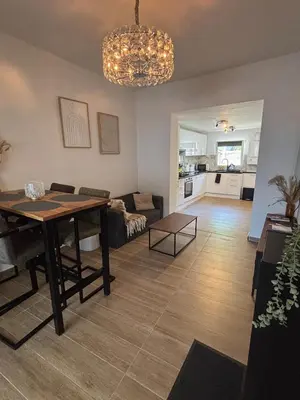 a living room with a table and a couch at Modern apartment in Brussels, ground floor in Brussels