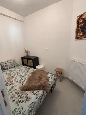 a bedroom with a bed with a rug on it at Modern apartment in Brussels, ground floor in Brussels