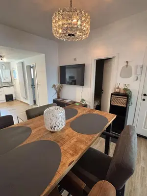 a dining room and living room with a wooden table at Modern apartment in Brussels, ground floor in Brussels