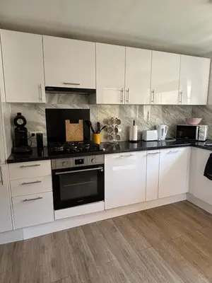 a kitchen with white cabinets and a stove at Modern apartment in Brussels, ground floor in Brussels