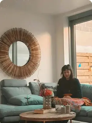 a woman sitting on a couch in a living room at Mi casa es su casa in Ghent