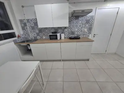 a kitchen with white cabinets and a counter with a microwave at Nice apartment close to Zaventem airport in Kampenhout