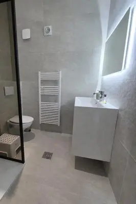 a bathroom with a white sink and a toilet at Nice apartment close to Zaventem airport in Kampenhout