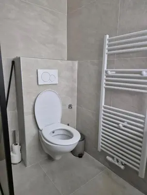 a small bathroom with a toilet and a shower at Nice apartment close to Zaventem airport in Kampenhout