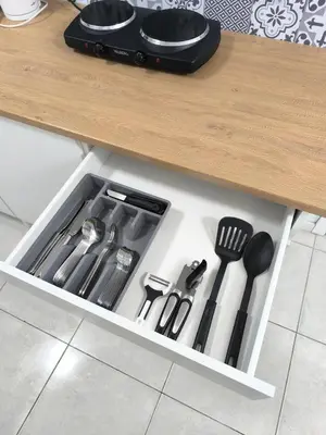a drawer filled with cooking utensils under a counter at Nice apartment close to Zaventem airport in Kampenhout
