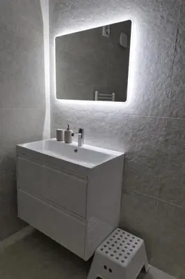 a white bathroom with a sink and a mirror at Nice apartment close to Zaventem airport in Kampenhout