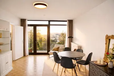 a living room with a table and chairs at Avenue Louise skyline view in Brussels
