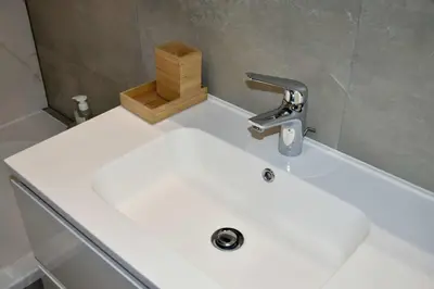 a white sink with a faucet on top of it at Avenue Louise skyline view in Brussels