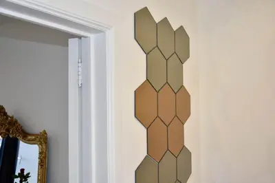 a wooden wall art in a room with a mirror at Avenue Louise skyline view in Brussels