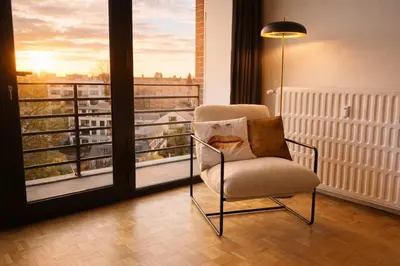 a chair in a room with a view of a balcony at Avenue Louise skyline view in Brussels