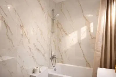a bathroom with a shower and a tub and a sink at Avenue Louise skyline view in Brussels