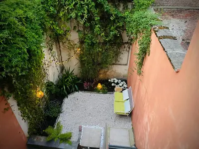 an overhead view of a garden with a chair and plants at Alcazar in Mechelen