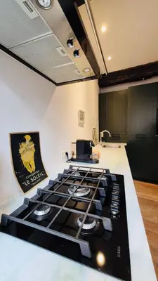 a kitchen with a stove top in a room at Alcazar in Mechelen