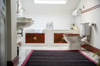 a white bathroom with a sink and a toilet at Papillon Boutique Villa Centre Antwerp in Antwerp