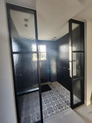 a walk in shower with a glass door in a room at Obobonne in Geraardsbergen